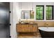 Stylish bathroom featuring a modern vanity, black accent door, and freestanding tub at 942 Fairfield, Marietta, GA 30068