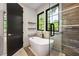 Bathroom with a freestanding tub, a glass-enclosed shower, and a view of the outdoors at 942 Fairfield, Marietta, GA 30068