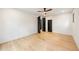 Bright bedroom features pale hardwood floors, a ceiling fan, and multiple dark-toned interior doors at 942 Fairfield, Marietta, GA 30068