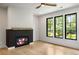 Bedroom featuring a modern fireplace with an adjacent bathroom and hardwood floors at 942 Fairfield, Marietta, GA 30068