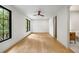 Spacious bedroom features light hardwood floors, a ceiling fan, and an ensuite bathroom at 942 Fairfield, Marietta, GA 30068