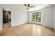 Bright bedroom featuring light hardwood floors, large windows, and ensuite bathroom with glass shower at 942 Fairfield, Marietta, GA 30068