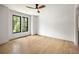 Bedroom featuring light hardwood floors, a ceiling fan, and large windows with green views at 942 Fairfield, Marietta, GA 30068