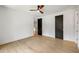 This airy bedroom has hardwood floors, a ceiling fan, and multiple dark-toned interior doors at 942 Fairfield, Marietta, GA 30068