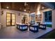 Stylish covered patio featuring a comfortable seating area, ceiling fan, and outdoor fireplace at 942 Fairfield, Marietta, GA 30068