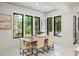 Bright dining room with large windows offering scenic backyard views and a stylish dining set at 942 Fairfield, Marietta, GA 30068