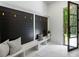 Inviting entryway with a built-in bench, black accent wall, and glass front door at 942 Fairfield, Marietta, GA 30068