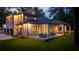 Beautiful backyard view of this modern home with covered patio, lush lawn, and three-car garage at 942 Fairfield, Marietta, GA 30068