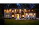 Stately home exterior at night featuring warm lighting, manicured lawn, and inviting curb appeal at 942 Fairfield, Marietta, GA 30068