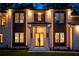 Elegant home exterior with a well-lit entrance, beautiful landscaping, and a manicured lawn at 942 Fairfield, Marietta, GA 30068