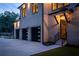 Attached three car garage with minimalist door design and manicured landscaping at 942 Fairfield, Marietta, GA 30068
