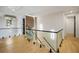 Bright hallway featuring hardwood floors, glass railings, and modern lighting fixtures at 942 Fairfield, Marietta, GA 30068