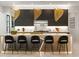 Sleek kitchen island with barstool seating illuminated by three unique pendant lights, combining style and function at 942 Fairfield, Marietta, GA 30068