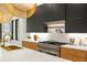 Modern kitchen with high-end appliances, waterfall countertops, and dark modern wooden cabinets at 942 Fairfield, Marietta, GA 30068