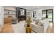 Bright, open living room with fireplace, built-in shelves, and access to the backyard through glass doors at 942 Fairfield, Marietta, GA 30068