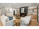 Inviting living room with a fireplace, wooden floors, and a modern staircase leading to the upper level at 942 Fairfield, Marietta, GA 30068