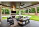 This cozy covered patio features an outdoor fireplace, ceiling fan, and comfortable seating area at 942 Fairfield, Marietta, GA 30068