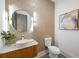Stylish powder room featuring a unique vessel sink, decorative mirror, and elegant wall coverings at 942 Fairfield, Marietta, GA 30068