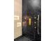 Detailed view of a modern shower featuring black marble and gold fixtures and controls at 942 Fairfield, Marietta, GA 30068