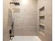 Modern shower featuring upscale tile work, shower head, and built-in shelving at 942 Fairfield, Marietta, GA 30068