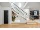Contemporary staircase featuring glass railings, hardwood floors, and decorative plants at 942 Fairfield, Marietta, GA 30068