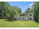 Lush green backyard of a home, framed by mature trees and well-maintained landscaping, creating a serene outdoor space at 1031 Bailey Rd, Woodstock, GA 30188