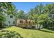 Expansive backyard featuring a large deck perfect for outdoor entertaining, surrounded by lush greenery and mature trees at 1031 Bailey Rd, Woodstock, GA 30188