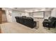Recreational basement with theater screen, black leather sofas, and a staircase to the upper level at 1031 Bailey Rd, Woodstock, GA 30188