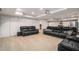 Finished basement with black leather sofas, a projector screen, and recessed lighting for a home theater experience at 1031 Bailey Rd, Woodstock, GA 30188