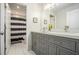 Well-lit bathroom with a double vanity, modern hardware, and an adjacent toilet room with a shower/tub combo at 1031 Bailey Rd, Woodstock, GA 30188