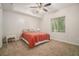 Cozy bedroom featuring neutral walls, plush carpet, ceiling fan, and natural light from the large window at 1031 Bailey Rd, Woodstock, GA 30188