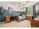 Comfortable bedroom showcasing a two-tone paint scheme, functional desk area, and matching wooden furniture at 1031 Bailey Rd, Woodstock, GA 30188
