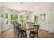 Charming dining room with wood floors, large windows, and a stylish light fixture above a wooden table at 1031 Bailey Rd, Woodstock, GA 30188