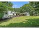 Beautiful white exterior home with well-manicured lawn and a welcoming front porch lined with rocking chairs at 1031 Bailey Rd, Woodstock, GA 30188