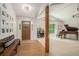 Welcoming foyer with bench seating, wood floors and a view into a formal sitting room with grand piano at 1031 Bailey Rd, Woodstock, GA 30188