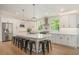 Modern kitchen with white cabinetry, a large center island with seating, and stainless steel appliances at 1031 Bailey Rd, Woodstock, GA 30188