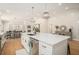 Bright kitchen island with stainless steel appliances, open layout design, and modern pendant lighting at 1031 Bailey Rd, Woodstock, GA 30188