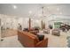 Open-concept living room with comfortable seating, wood flooring, and seamless flow to adjacent spaces at 1031 Bailey Rd, Woodstock, GA 30188
