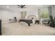 Spacious main bedroom with white shiplap accent wall, neutral carpet, a ceiling fan, and ample natural light at 1031 Bailey Rd, Woodstock, GA 30188