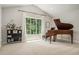 Elegant sitting room featuring a grand piano, a large window with views, and neutral carpeting at 1031 Bailey Rd, Woodstock, GA 30188
