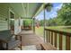 Relaxing screened porch with wooden floors, swing, and views of the expansive green backyard at 225 W Union Grove Cir, Auburn, GA 30011