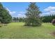 Lush backyard with mature trees and a wide open space, perfect for outdoor activities at 225 W Union Grove Cir, Auburn, GA 30011