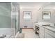Well-lit bathroom featuring a soaking tub and a glass-enclosed shower at 225 W Union Grove Cir, Auburn, GA 30011
