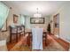 Elegant dining room with hardwood floors, stylish chandelier, and ample natural light at 225 W Union Grove Cir, Auburn, GA 30011