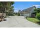 Wide driveway with a basketball hoop, leading to a two-car garage and a landscaped yard at 225 W Union Grove Cir, Auburn, GA 30011