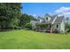 A meticulously manicured front yard showcases a charming two-story home with a cozy front porch at 225 W Union Grove Cir, Auburn, GA 30011