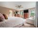 Spacious main bedroom with large windows, a ceiling fan, and ample closet space at 225 W Union Grove Cir, Auburn, GA 30011