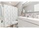 Cozy bathroom with a modern white vanity and shower with a starfish curtain at 242 Sandhurst Ct, Suwanee, GA 30024