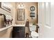 Charming powder room with stylish fixtures, decorative mirror, and elegant details at 242 Sandhurst Ct, Suwanee, GA 30024
