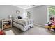 Comfortable bedroom with neutral walls, natural light, and carpet flooring at 242 Sandhurst Ct, Suwanee, GA 30024